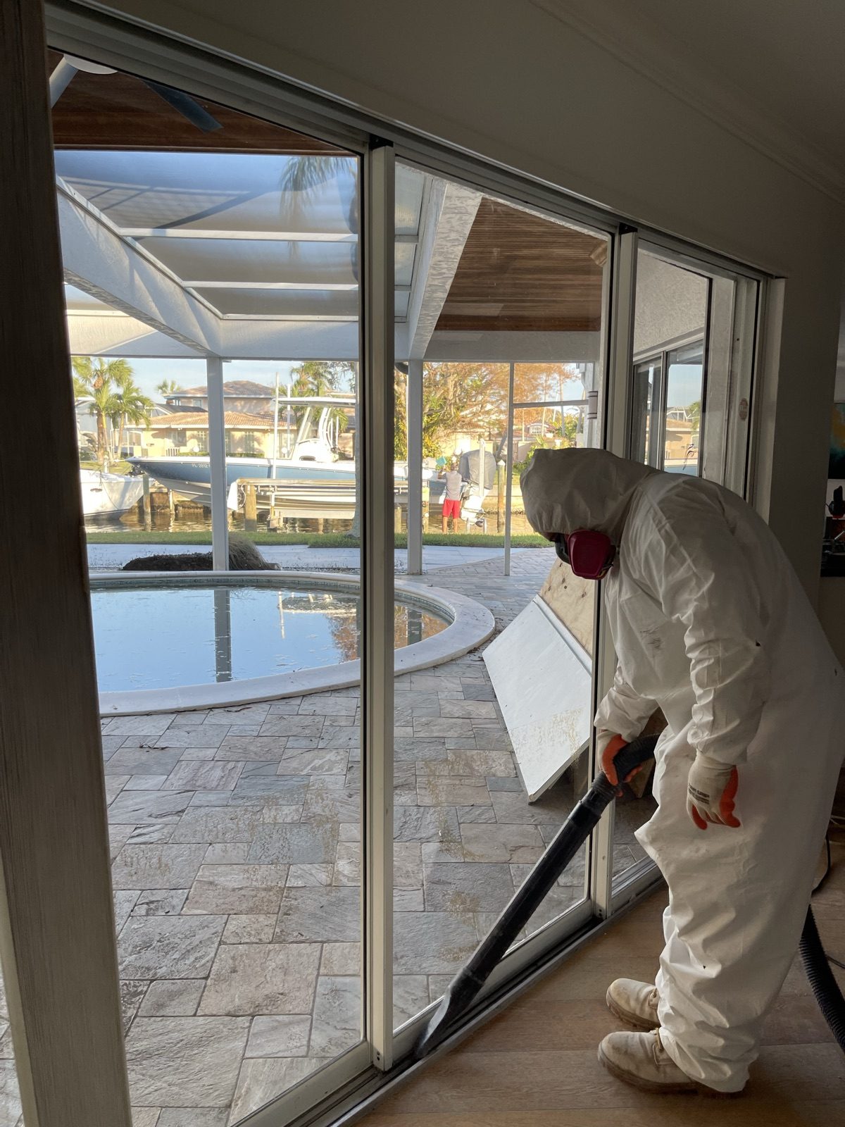 Technician performing water extraction at a waterfront property after a storm